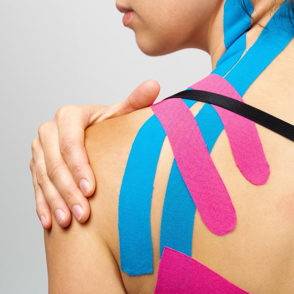 Kinesiotaping, kinesiology. Female athlete with kinesiotape, muscle tape on shoulder